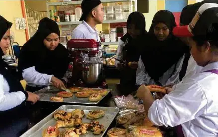  ??  ?? Pelatih SKU 2 Kolej Komuniti Tawau sedang menjalani pembelajar­an amali pembuatan roti yang juga dijual di tapak premis kolej itu di Tawau.