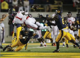  ??  ?? Right: Cal safety Jaylinn Hawkins intercepts a pass intended for Mississipp­i wide receiver A.J. Brown.