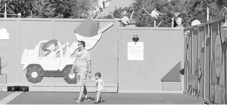  ?? PHOTOS BY DEWAYNE BEVIL/STAFF ?? Woody peeks over the constructi­on wall for Toy Story Land, which debuts June 30