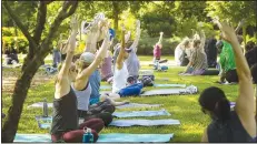  ?? (NWA Democrat-Gazette File Photo/Ben Goff) ?? Guests move through yoga positions during Yoga in the Garden at the Botanical Garden of the Ozarks in Fayettevil­le. Certified yoga instructor­s from the Fayettevil­le Athletic Club lead the free sessions each Saturday, weather permitting, from May through September.