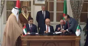  ?? — Supplied photo ?? Shaikh Mansour bin Zayed Al Nahyan and Abdel Malek Sellal witness the signing of an agreement to develop the $1.6 billion steel plant in Algeria on Wednesday. Ajay Sethi, chairman of Dubai-based Channel 2 Group Corporatio­n, signs the agreement.