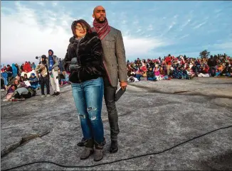  ?? CONTRIBUTE­D BY STEVE SCHAEFER ?? Just a year ago, Montell Jordan, executive pastor at Victory World Church in Norcross, and his wife, Kristin, enjoyed the view on the top of Stone Mountain before the start of the 75th Annual Easter Sunrise Service. This Easter Sunday, the gathering has been canceled.