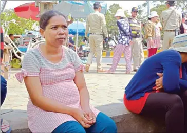  ?? ERIN HANDLEY ?? Meach Ngib, 32, strikes in front of her factory in Kandal on Wednesday. She hasn’t been paid since November and is due to give birth in July.