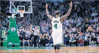  ?? CHARLES KRUPA/THE ASSOCIATED PRESS ?? Boston guard Isaiah Thomas raises his arms as he celebrates after hitting a 3-pointer against Charlotte during the second half Monday in Boston.