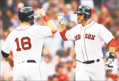  ?? Adam Glanzman / Getty Images ?? J.D. Martinez, right, celebrates his two-run home run with Mitch Moreland in the fifth inning against the Orioles on Sunday.