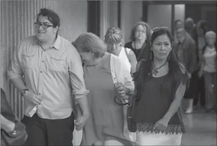  ?? DARREN CALABRESE, THE CANADIAN PRESS ?? Taylor Samson’s brother Connor, left, and his mother Linda Boutilier, centre, leave the court after victim impact statements were read.