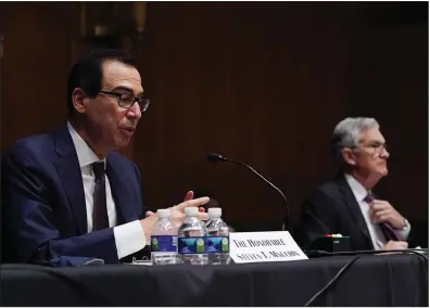  ?? (The Washington Post/Toni L. Sandys) ?? Federal Reserve Chairman Jerome Powell listens Wednesday as Treasury Secretary Steve Mnuchin testifies during the Senate’s Committee on Banking, Housing and Urban Affairs hearing on Capitol Hill.