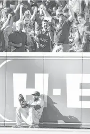  ?? Karen Warren / Houston Chronicle ?? Jays right fielder Jose Bautista slumps to the ground after Josh Reddick’s homer lands in the seats in the first inning. The fan in the first row made the play.