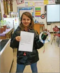  ?? COURTESY OF DEB DUSHKO ?? Edward R. Andrews Elementary School sixth-grader Robin Colvin, 12, shows one of her crafty dreamcatch­ers and a sheet explaining their Native American origins in this recent photo.