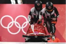  ?? MARK RALSTON/AFP/GETTY IMAGES ?? Canada’s Phylicia George, left, and Kaillie Humphries were fifth after two runs Tuesday. Three Canadian sleds were in the top eight.