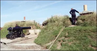  ??  ?? Craig Hyatt, assistant program manager at the Halifax Citadel Regimental Associatio­n, checks for people in the concussion zone‚ from the remparts of Citadel Hill just before firing the noon gun. The noon gun is fired year round by historical re-...