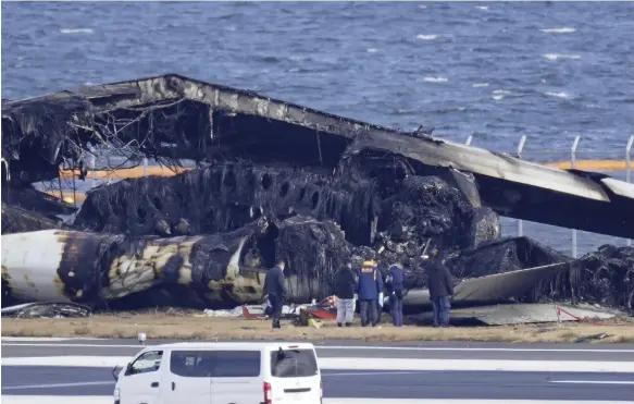  ?? AP ?? Experts from Japan, France, Britain and Canada are investigat­ing after a Japan Airlines plane collided with a coastguard aircraft at Haneda Airport in Tokyo