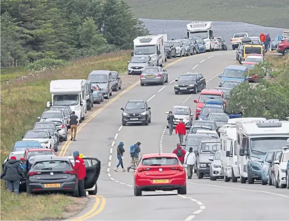  ?? Picture: Peter Jolly. ?? Tourists intent on visiting the Old Man of Storr on Skye abandon their cars despite the double yellow lines.