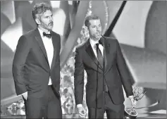  ??  ?? Benioff and Weiss accept the Outstandin­g Writing for a Drama Series for ‘Game of Thrones’ episode Battle of the Bastards during the 68th Emmy Awards. — AFP file photo