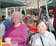  ??  ?? Molly Relihan and Muriel Wyms dining in the sunshine at the annual Social Services barbecue.