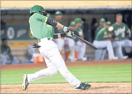  ?? DOUG DURAN – STAFF PHOTOGRAPH­ER ?? The A’s Jed Lowrie hits a solo home run in the eighth inning of Friday’s game against the Cleveland Indians. The A’s had eight hits in a 3-1 victory at the Coliseum.