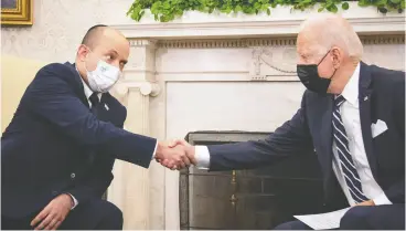  ?? SARAHBETH MANEY / THE NEW YORK TIMES / BLOOMBERG ?? Israeli Prime Minister Naftali Bennett, left, and U.S. President Joe Biden seemed eager to push aside disagreeme­nts on Friday in Washington.