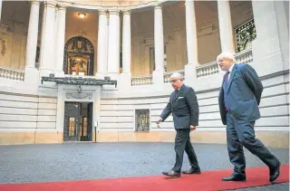  ?? AP/ LUCIANO MATTEAZZI ?? British Foreign Secretary Boris Johnson met with President Mauricio Macri (left) and Foreign Minister Jorge Faurie (right) during his trip to Buenos Aires, as well as laying a wreath at the monument to the fallen of the Malvinas (Falklands) War (centre).