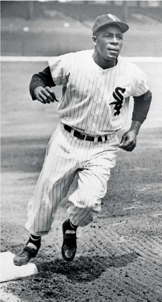  ?? AP ?? Legendary Sox outfielder Minnie Minoso goes through a baserunnin­g drill at Comiskey Park in 1955. His three seasons in the Negro Leagues prevented him from putting up even better numbers than he did.