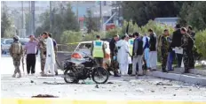  ?? — Reuters ?? Afghan security forces inspect the site of a suicide attack in Kabul.