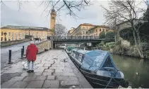  ?? PICTURES: ADOBESTOCK / BBC / BRUCE ROLLINSON. ?? WATERS TO PLY: Main picture, boats moored on the Leeds & Liverpool Canal near Wigan; top, Robbie opening a lock; above right, the wooden lock gates on the Aire & Calder Navigation with a view of Sowerby Bridge; middle, the towpath by Salts Mil; above, navigating past Ferrybridg­e power station’s towers.