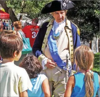  ??  ?? Children visit with Gen. George Washington during a Chadds Ford Days festival. The 52nd annual celebratio­n returns to the grounds of the Chadds Ford Historical Society Sept. 9-10.