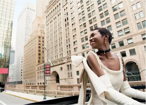  ??  ?? Riding uptown in style.
Simone Rocha silk-taffeta mega-bow cape dress, `2,22,302, 71 Wooster St., N.Y.C. Carolina Amato Contessa gloves, `34,887, amatonewyo­rk.com; Larkspur & Hawk earrings in rose gold with honey citrines and champagne diamonds, `6,52,764, larkspuran­dhawk.com; Mateo New York velvet choker with diamond, malachite, and gold drop, `32,638, mateonewyo­rk.com. Thank you to Statue Cruises; Top of the Rock; Brooklyn Bridge; Brooklyn Bridge Park; the Beekman, a Thompson Hotel; and the team at NYC & Company.