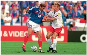  ??  ?? Denmark…Allan Nielsen tussles with Zidane for the ball