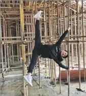  ??  ?? Wang practices pole dancing on scaffolds at a constructi­on site in Jiaxing.