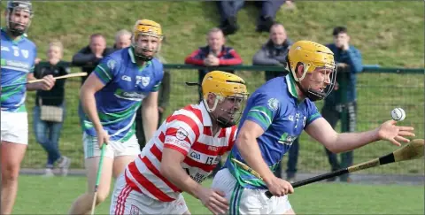  ??  ?? Alan Cowman of Glynn-Barntown is pursued by Ferns St. Aidan’s goalscorer Christophe­r O’Connor.