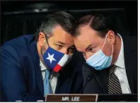  ?? (AP/The Washington Post/Bill O’Leary/Pool) ?? Sen. Ted Cruz (left), R-Texas, confers with Sen. Mike Lee, R-Utah, during Thursday’s confirmati­on hearing for Supreme Court nominee Amy Coney Barrett. The committee scheduled an Oct. 22 vote to recommend the nomination to the full Senate.