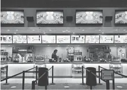  ?? BRIDGET BENNETT/THE NEW YORK TIMES ?? The concession bar is empty of customers last month at a Galaxy Theaters in Las Vegas.