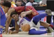  ?? TONY DEJAK — ASSOCIATED PRESS ?? Collin Sexton and the Pistons’ Langston Galloway battle for a loose ball during the first half March 2.