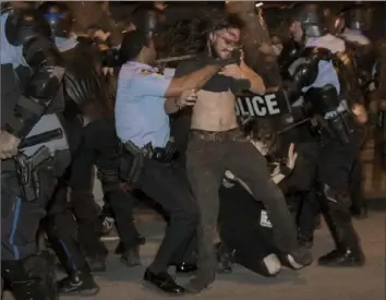  ?? Chris Granger/The Advocate via AP ?? New Orleans police clash with protesters on top of the Crescent City Connection bridge Wednesday during a demonstrat­ion over police brutality and the death of George Floyd.