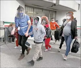  ?? Christian Chavez Associated Press ?? A MIGRANT FAMILY crosses the border Feb. 26 from Ciudad Juarez, Mexico, into El Paso. An escalation in arrivals of unaccompan­ied minors began last year.