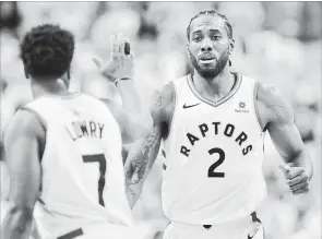  ?? FRANK GUNN THE CANADIAN PRESS ?? Toronto Raptors forward Kawhi Leonard, right, dominated Game 1 against the Philadelph­ia 76ers unlike anything Kyle Lowry has even seen — almost.