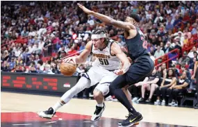  ?? — AFP photo ?? Aaron Gordon of the Denver Nuggets drives against Haywood Highsmith of the Miami Heat.
