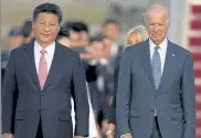  ?? CAROLYN KASTER / AP ?? Chinese President Xi Jinping and Vice President Joe Biden walk down the red carpet on the tarmac during an arrival ceremony in Andrews Air Force Base, Md., Sept. 24, 2015.
