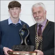  ??  ?? Fionn Byrne accepting the Duais Uí Mhorda Award from Cllr Jim Moore.