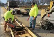  ?? NEWS-HERALD FILE ?? Cole Eden of Eden’s Excavating, left, and Keith Skinner of Mountainvi­ew Contractin­g work on a median and catch basin repair project for the City of Eastlake on Route 91 near Stevens Boulevard in April 2017.