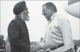  ?? Jim Watson
Pool Photo ?? U.S. DEFENSE CHIEF Leon Panetta is welcomed by Singapore’s Sarbjit Singh upon arrival in the country for an annual conference of Asian defense officials.