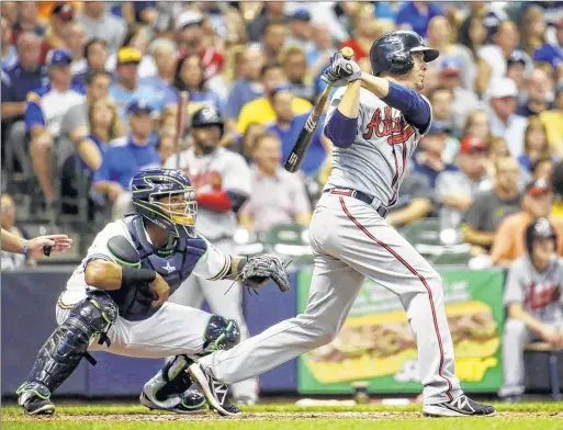  ??  ?? Atlanta’s Kelly Johnson hit an RBI single during the second inning against the Brewers on Monday night. The Braves raced out to an early 4-1 lead.
ASSOCIATED PRESS