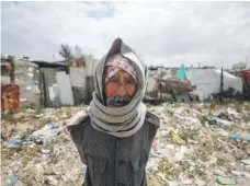  ?? AFP ?? Top, a man carries relief goods at the Shati camp for Palestinia­n refugees in Gaza; above, a refugee awaits aid in Gaza