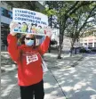  ?? Matthew Brown / Hearst Connecticu­t Media ?? Diane Phanos, president of Stamford’s teachers union, along with teachers, parents and other community members, attends a “rolling” rally around the Stamford Government Center Thursday to urge city officials not to impose more than $15 million in cuts to education.