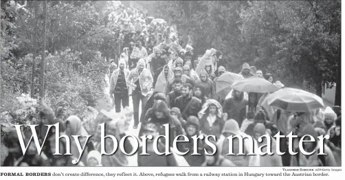  ?? Vladimir Simicek AFP/Getty Images ?? FORMAL BORDERS don’t create difference, they ref lect it. Above, refugees walk from a railway station in Hungary toward the Austrian border.