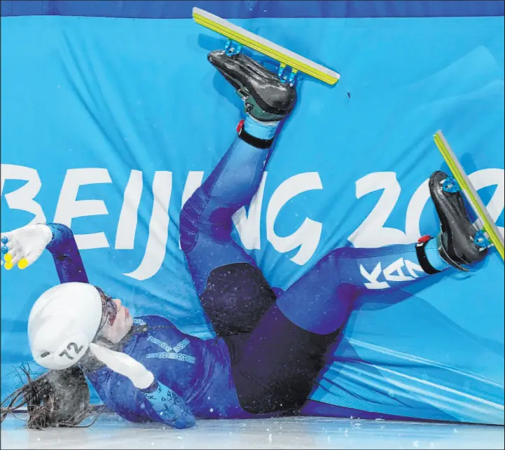  ?? Natacha Pisarenko The Associated Press ?? Olga Tikhonova of Kazakhstan crashes in her heat of the women’s short track speedskati­ng 1,000 meters Wednesday at the 2022 Winter Olympics in Beijing.