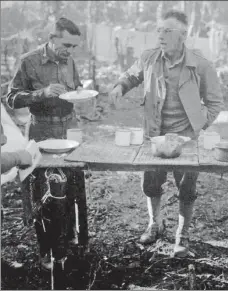  ?? PROVIDED TO CHINA DAILY ?? General Stilwell (right) eats an open-air breakfast at a crude table innorthern Burma in March 1944.