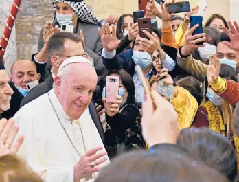  ?? VINCENZO PINTO/GETTY-AFP ?? A crowd flocks to Pope Francis as he arrives Sunday at the Church of the Immaculate Conception in Qaraqosh, Iraq. Francis wrapped up the day — and his visit to Iraq— with a Mass at the stadium in Irbil.