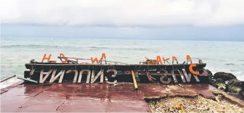  ??  ?? Remaining parts of an outdoor stage, where rock band Seventeen was performing when they were hit by a tsunami, lay on a shore at a resort in Tangung Lesung, Banten province, Indonesia. — Reuters photo