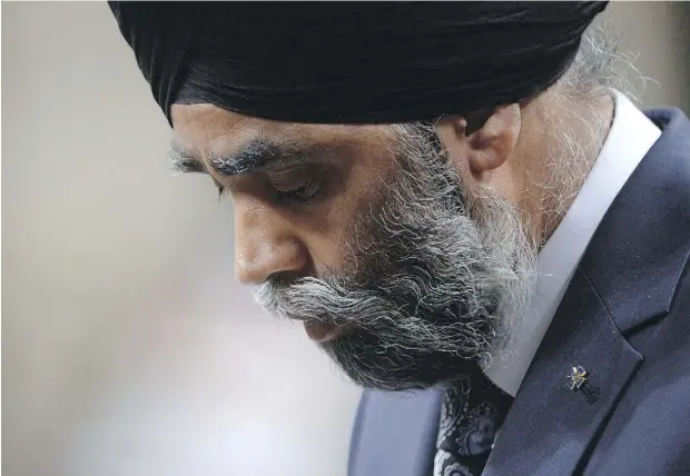  ?? ADRIAN WYLD / THE CANADIAN PRESS ?? Defence Minister Harjit Sajjan bows his head during question period in the House of Commons on Parliament Hill in Ottawa on Tuesday.